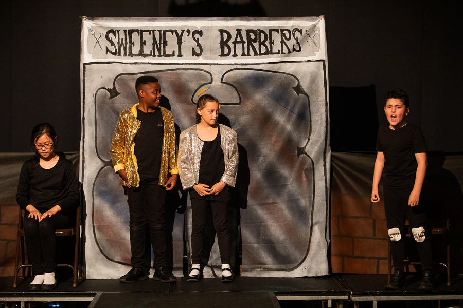 three school children acting in a workshop