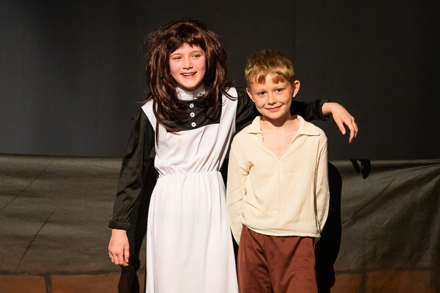 two kids perfmoring in a school workshop